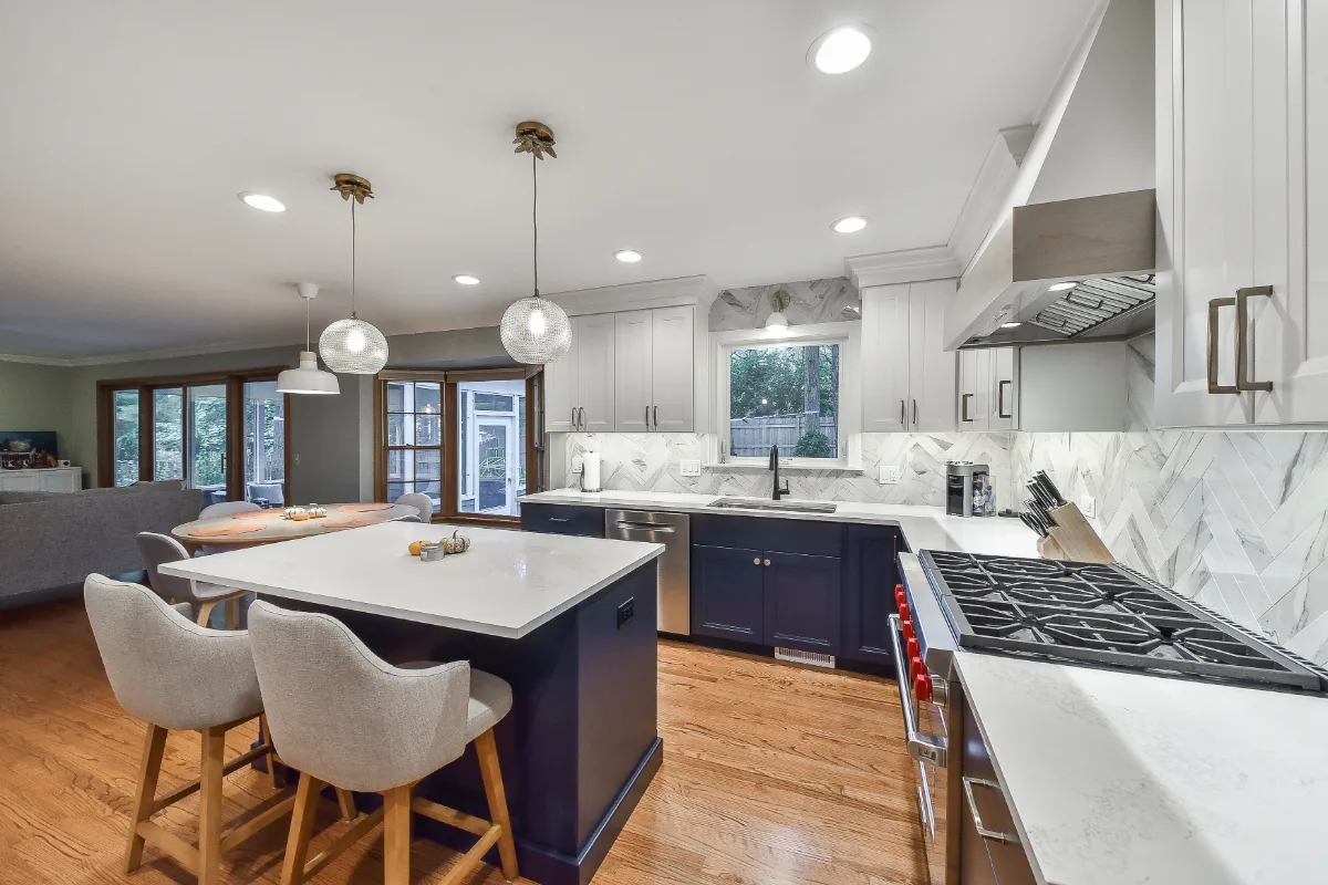 A modern-coastal kitchen remodel in Brentwood, Tennessee. Two-tone cabinetry, Caesarstone Calacatta Nuvo, and Matte Black fixtures by Sebring Design Build.