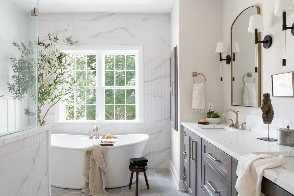 A coastal-elegant primary bath remodel in Willowsprings, Franklin TN 37064. Alder cabinetry, Calacatta Gold quartz, and Kohler Champagne Bronze by Sebring Design Build.