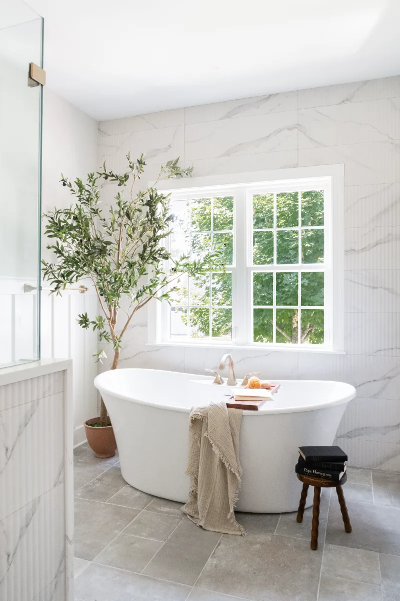 A coastal-elegant primary bath remodel in Willowsprings, Franklin TN 37064. Alder cabinetry, Calacatta Gold quartz, and Kohler Champagne Bronze by Sebring Design Build.