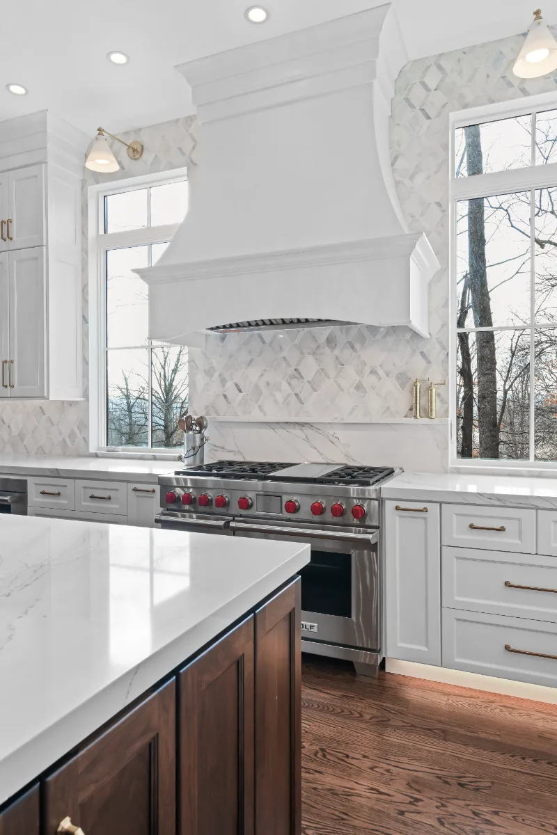 A Governors Club kitchen remodel in Brentwood, TN with an elegant, light palette. Custom cabinetry and refined finishes by Sebring Design Build.