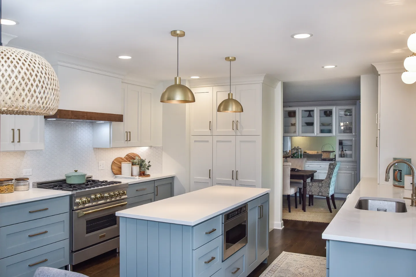Kitchen remodel in Brentwood, TN with blue and white cabinetry and gold accents. A refreshing interior kitchen transformation by Sebring Design Build.