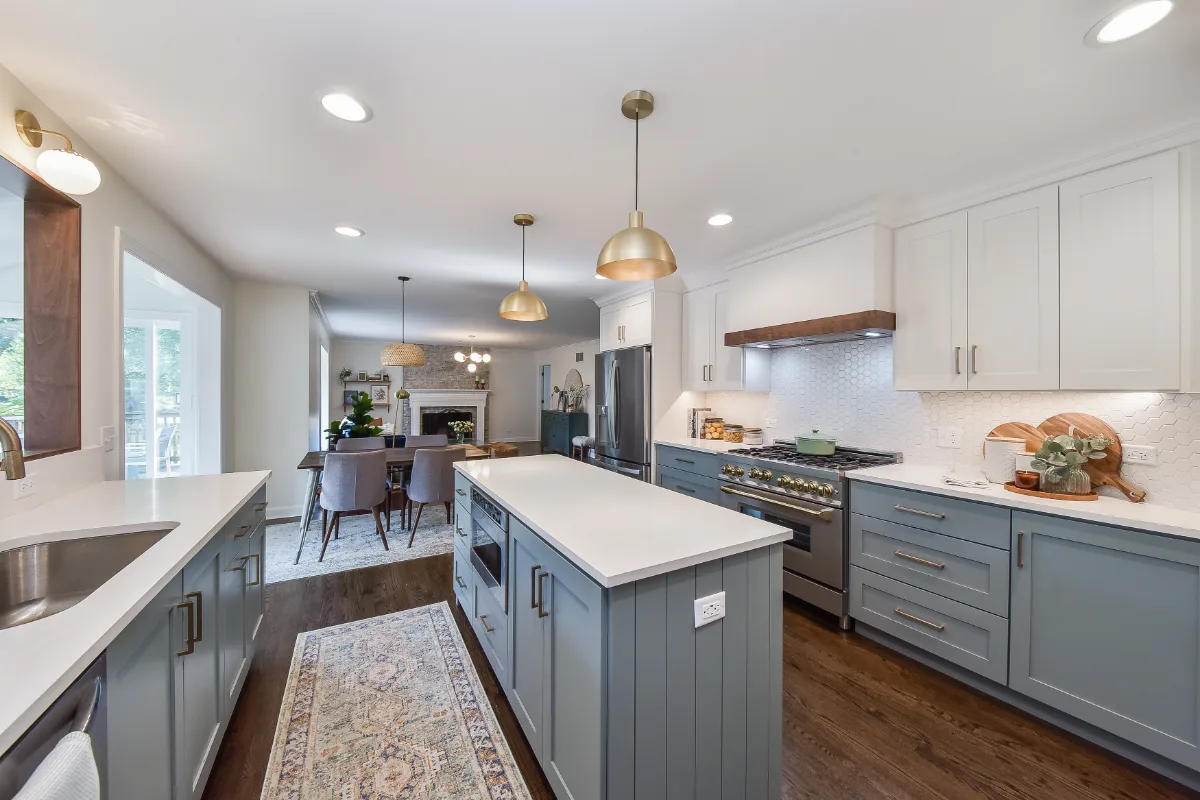 Kitchen remodel in Brentwood, TN with blue and white cabinetry and gold accents. A refreshing interior kitchen transformation by Sebring Design Build.