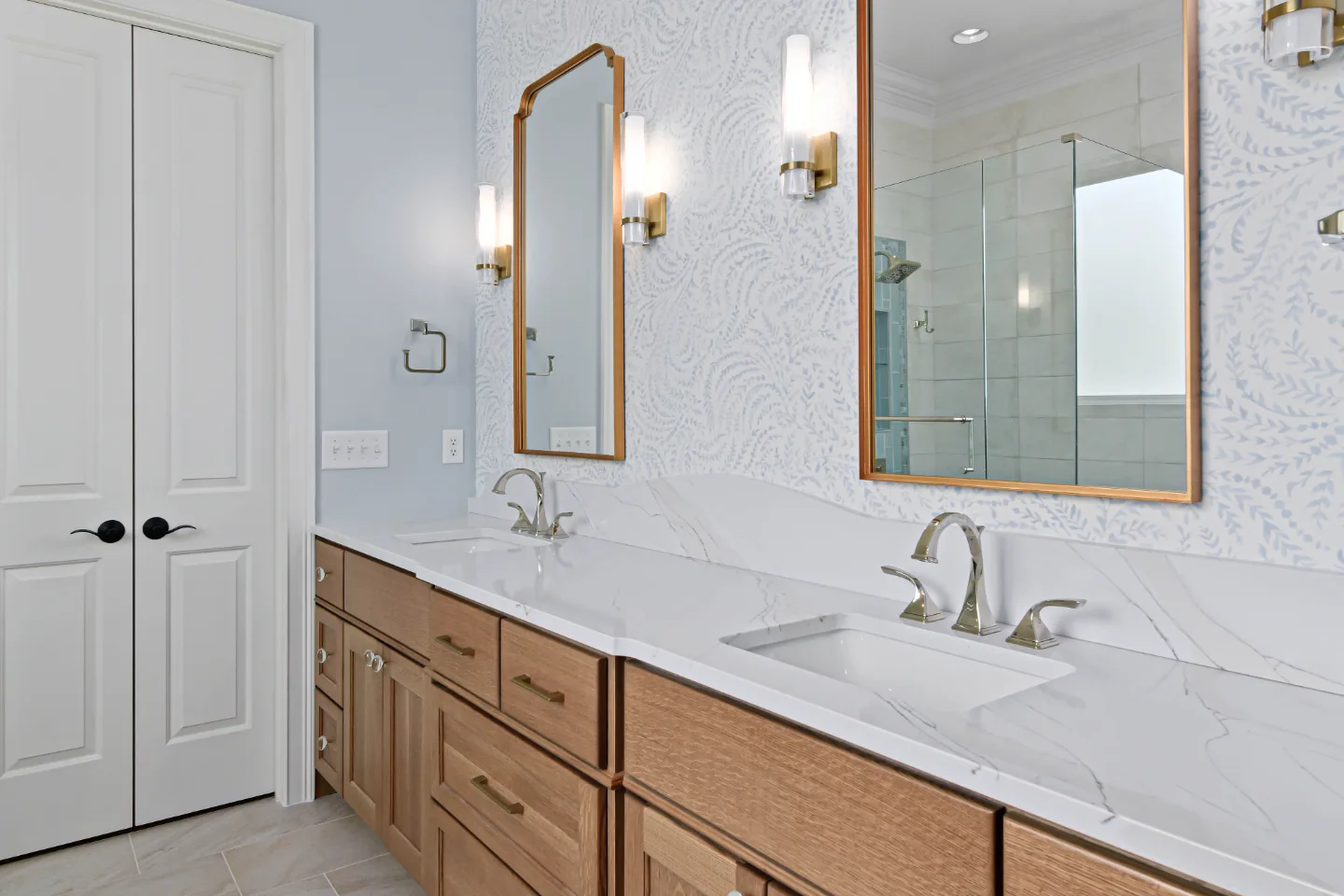 A modern-crisp-elegant primary bath remodel in Westhaven, Franklin TN 37064. CWP Quartersawn White Oak Sage cabinetry, MetroQuartz Calacatta Gold, Brizo Virage Polished Nickel, and Adex Blue Glossy accent tile by Sebring Design Build.
