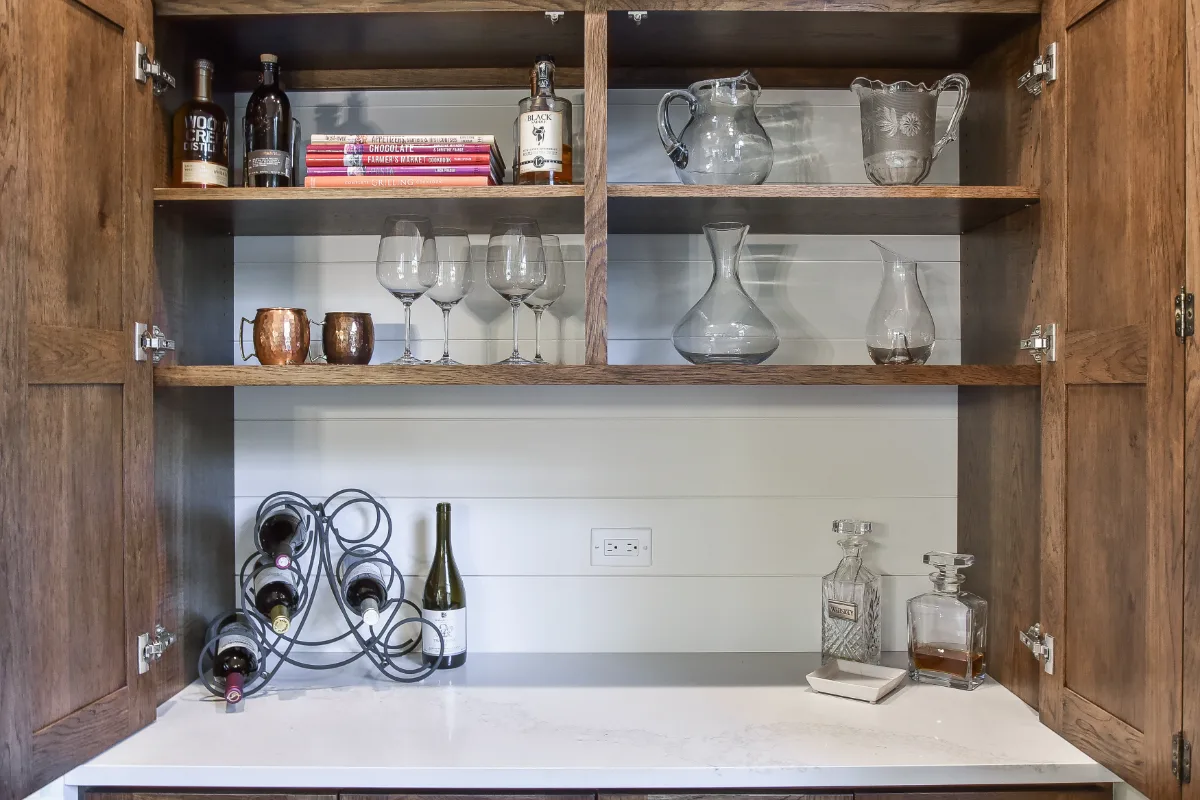 A transitional-organic kitchen remodel in Brentwood, TN. CWP Swiss Coffee and Hickory Praline cabinetry, Caesarstone Calacatta Nuvo quartz, and Delta Cassidy Champagne Bronze fixtures by Sebring Design Build.