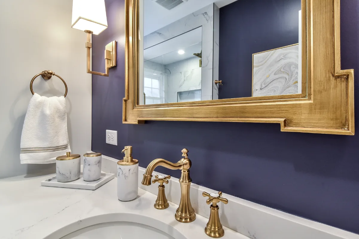 A retro-glamorous guest bath remodel in Brentwood, TN. CWP Havana Pearl cabinetry, Hanstone Yorkville quartz, and Moen Weymouth Brushed Gold fixtures by Sebring Design Build.