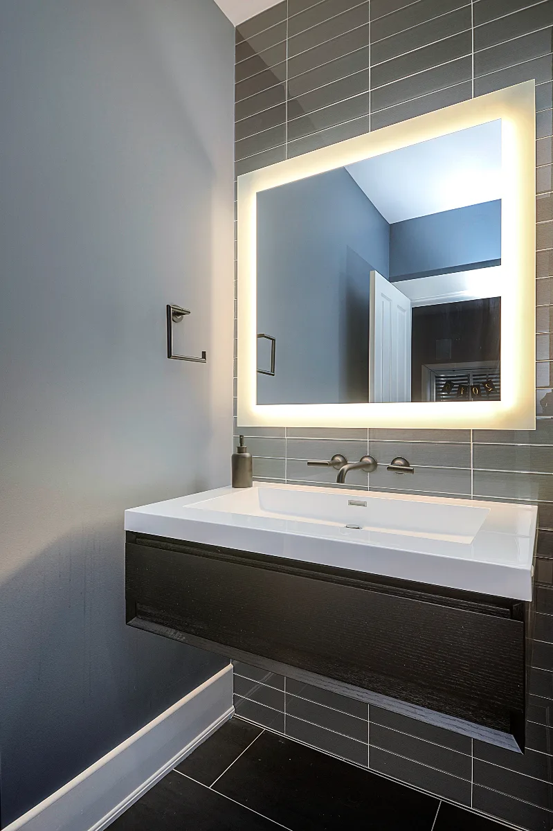 A modern-masculine basement remodel in Brentwood, TN with a dedicated bar, guest bath, and stage area by Sebring Design Build.
