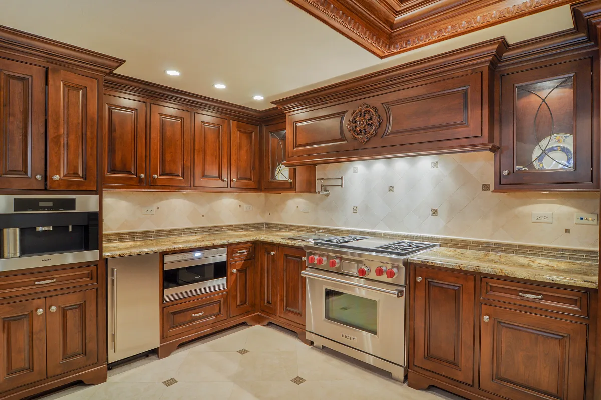 A traditional-intricate basement remodel in Franklin, TN. Coffered ceiling, custom carpentry, built-in entertainment unit, fireplace, bar, guest bath, gym, and dining room by Sebring Design Build.