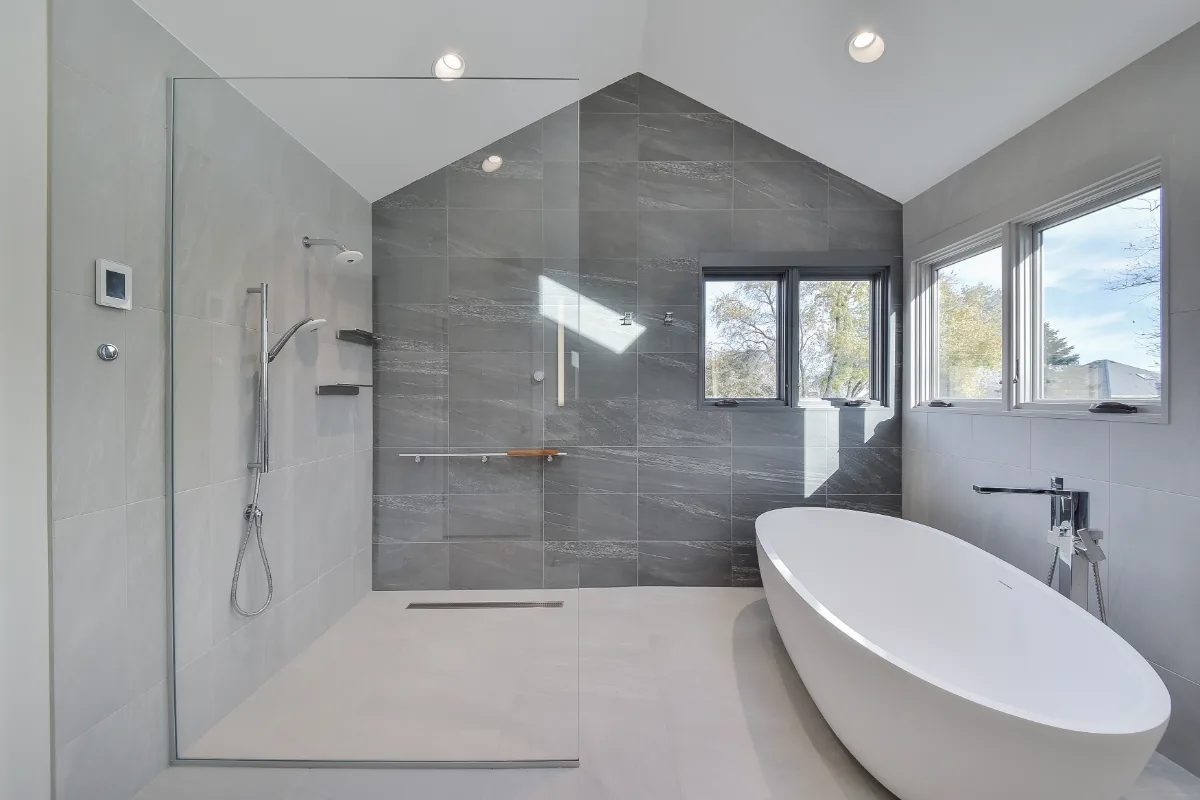 A modern-crisp primary bath remodel in Franklin, TN. CWP Walnut Ginger Slab cabinetry, CaesarStone Primordia quartz, Delta Pivotal Polished Chrome, and Virginia Tile Clash by Sebring Design Build.