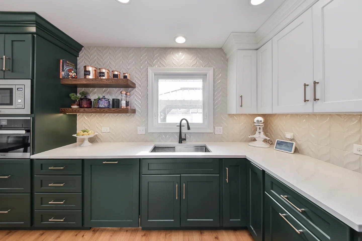A bold-green kitchen and dining room remodel in Franklin, TN. CWP Black Forest and Soft White cabinetry, Orion Calacatta Aria quartz, Moen Sleek Matte Black, and Amerock Destine Champagne Bronze by Sebring Design Build.
