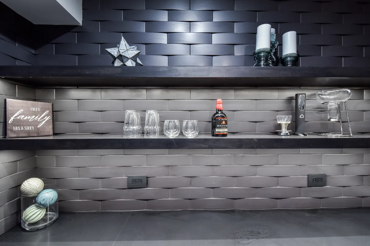 A transitional-unique basement remodel in Brentwood, TN with a bespoke bar and wine cellar. Bellmont Cabinetry, Cambria Blackpool matte quartz, and Amerock Matte Black hardware by Sebring Design Build.