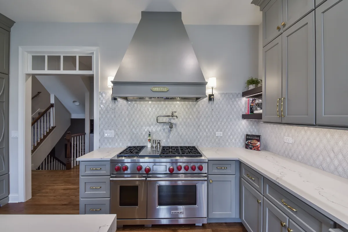 A transitional-elegant multi-room remodel in Brentwood, TN. Grand kitchen with CWP Fawn Brindle cabinetry, CaesarStone Statuario Nuvo, Kohler Artifacts Polished Nickel, and a brass powder room showstopper by Sebring Design Build.