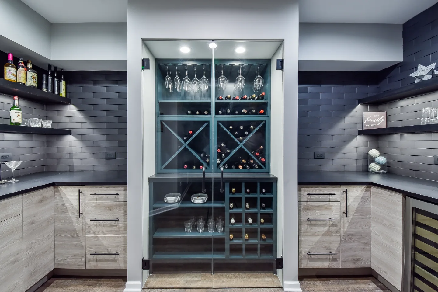 A transitional-unique basement remodel in Brentwood, TN with a bespoke bar and wine cellar. Bellmont Cabinetry, Cambria Blackpool matte quartz, and Amerock Matte Black hardware by Sebring Design Build.