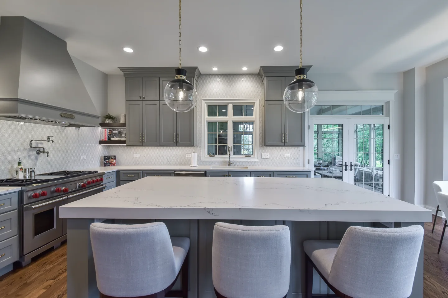 A transitional-elegant multi-room remodel in Brentwood, TN. Grand kitchen with CWP Fawn Brindle cabinetry, CaesarStone Statuario Nuvo, Kohler Artifacts Polished Nickel, and a brass powder room showstopper by Sebring Design Build.
