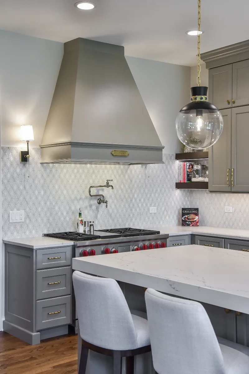 A transitional-elegant multi-room remodel in Brentwood, TN. Grand kitchen with CWP Fawn Brindle cabinetry, CaesarStone Statuario Nuvo, Kohler Artifacts Polished Nickel, and a brass powder room showstopper by Sebring Design Build.
