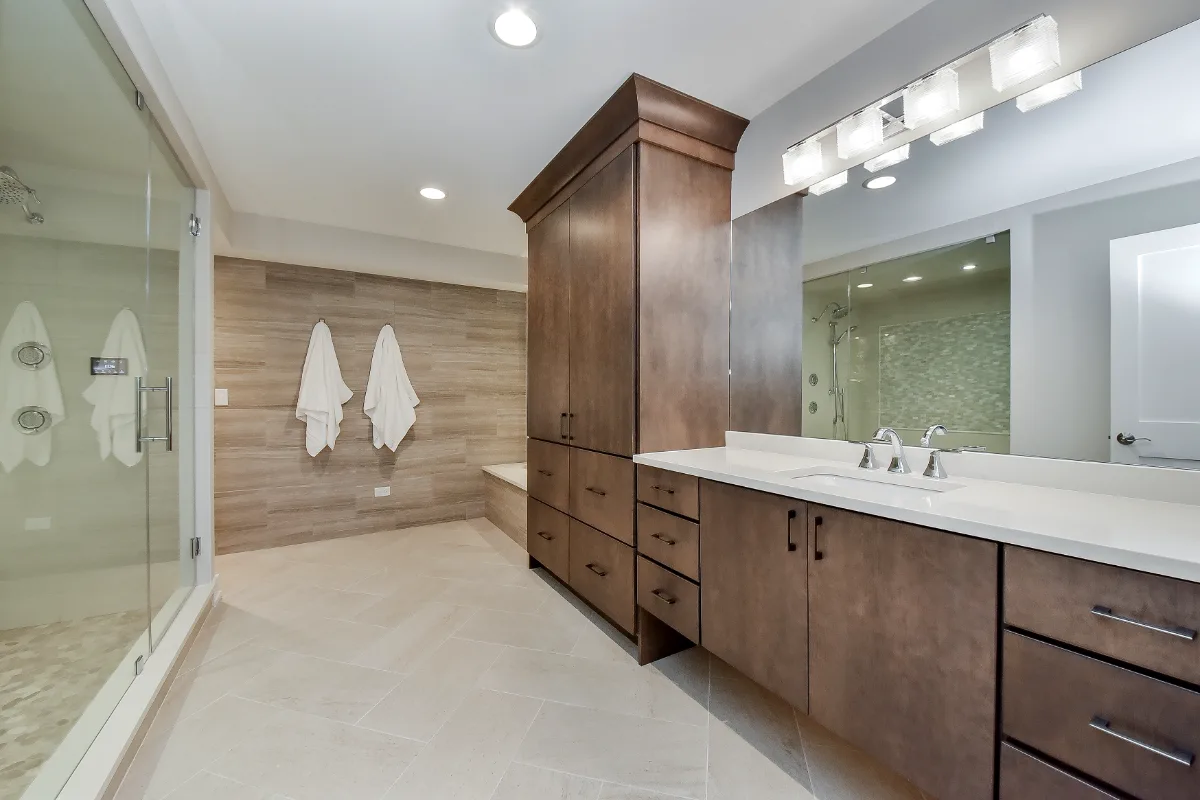 A functional-modern basement remodel in Franklin, TN with a guest bath, wet bar, workshop, and gym. Cambria Devon quartz and Moen Chrome fixtures by Sebring Design Build.
