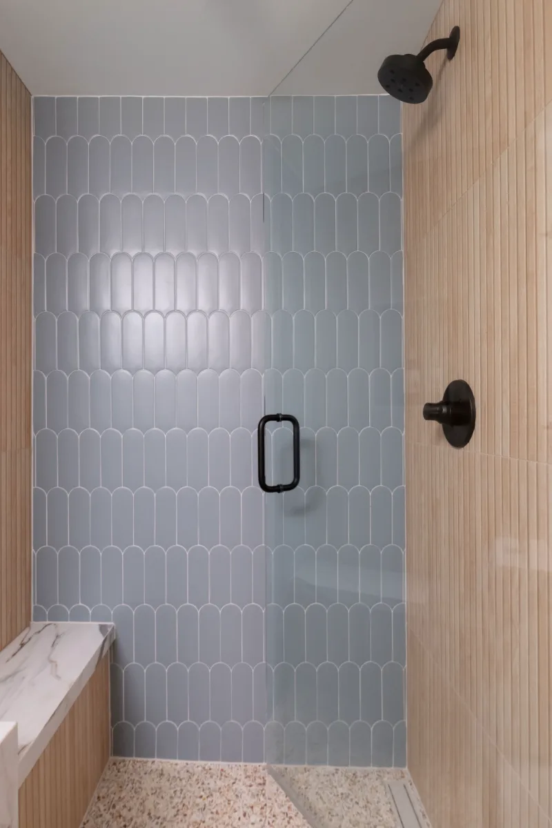 Guest Bath remodel in Franklin, TN. Sebring Design Build designed this Bonbrook basement guest bath in Brentwood, Tennessee with a modern-functional tile program featuring Kenridge Ribbon Maple shower walls.
