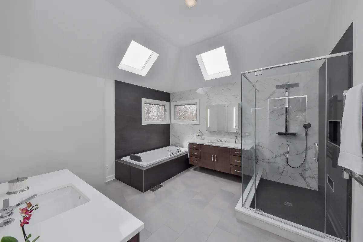 A modern-crisp primary bath remodel in Brentwood, TN. Wellborn Barcelona Oak Drift cabinetry, Orion Absolute White quartz, Atlas Concorde Calacatta Extra vanity wall, and Polished Chrome fixtures by Sebring Design Build.
