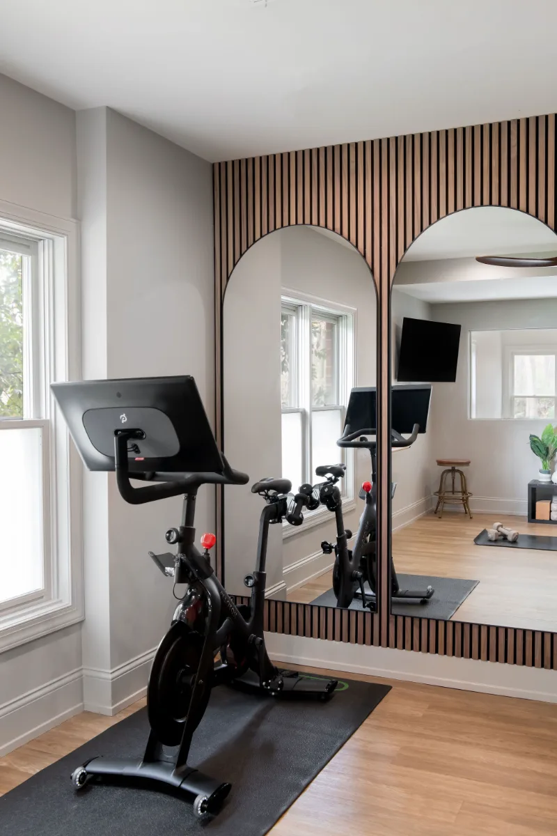 A modern-functional basement remodel in Bonbrook, Brentwood TN 37027. Custom SW Basil media wall cabinetry, Kilimanjaro quartz, acoustic wood slat panels, and LVP flooring by Sebring Design Build.