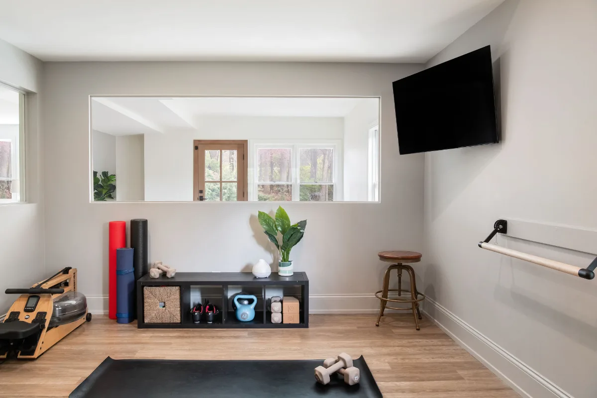 A modern-functional basement remodel in Bonbrook, Brentwood TN 37027. Custom SW Basil media wall cabinetry, Kilimanjaro quartz, acoustic wood slat panels, and LVP flooring by Sebring Design Build.