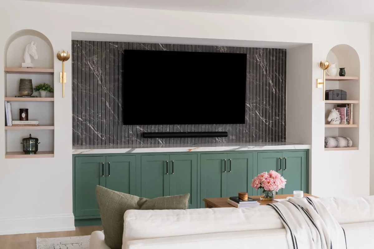 A modern-functional basement remodel in Bonbrook, Brentwood TN 37027. Custom SW Basil media wall cabinetry, Kilimanjaro quartz, acoustic wood slat panels, and LVP flooring by Sebring Design Build.