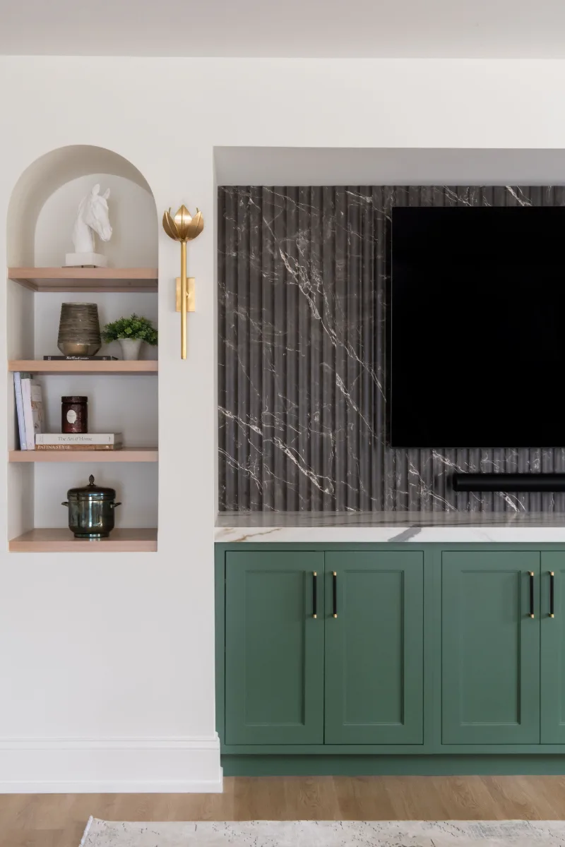 A modern-functional basement remodel in Bonbrook, Brentwood TN 37027. Custom SW Basil media wall cabinetry, Kilimanjaro quartz, acoustic wood slat panels, and LVP flooring by Sebring Design Build.