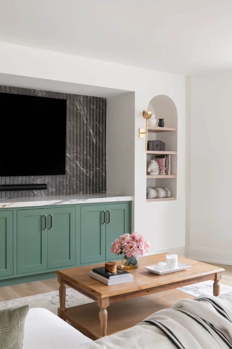 A modern-functional basement remodel in Bonbrook, Brentwood TN 37027. Custom SW Basil media wall cabinetry, Kilimanjaro quartz, acoustic wood slat panels, and LVP flooring by Sebring Design Build.