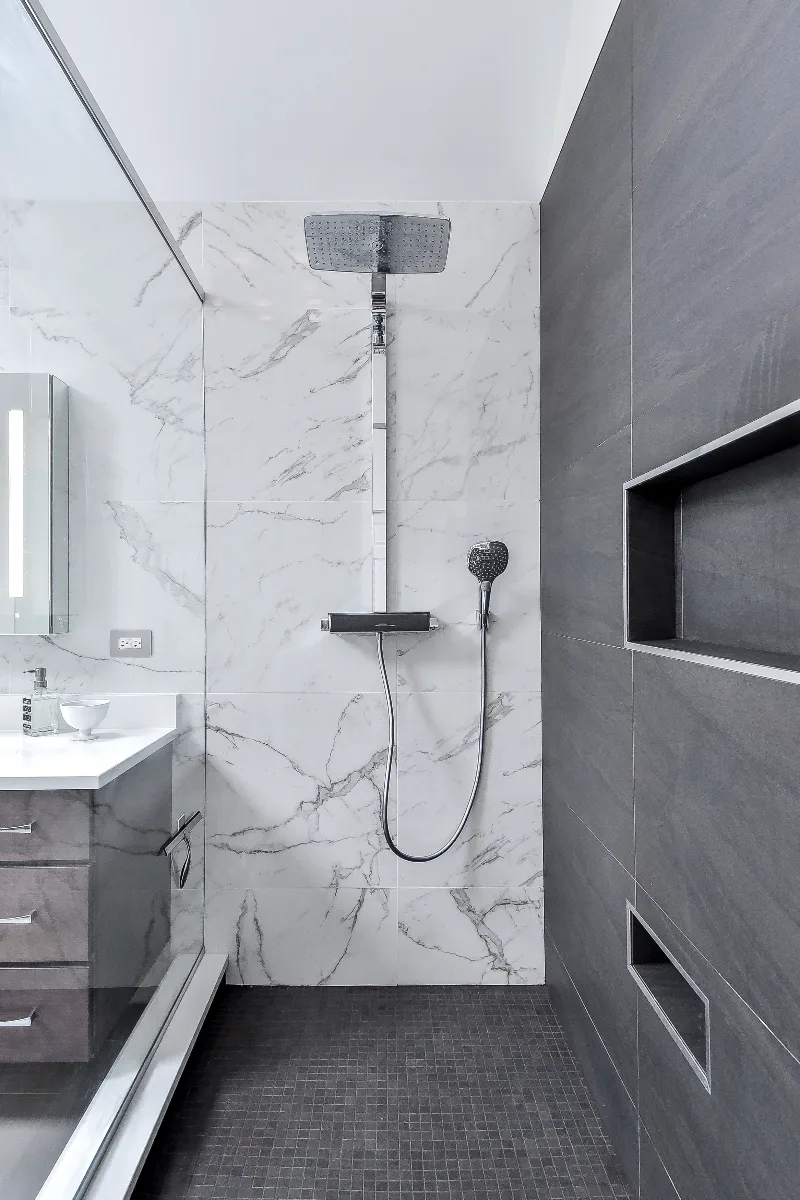 A modern-crisp primary bath remodel in Brentwood, TN. Wellborn Barcelona Oak Drift cabinetry, Orion Absolute White quartz, Atlas Concorde Calacatta Extra vanity wall, and Polished Chrome fixtures by Sebring Design Build.
