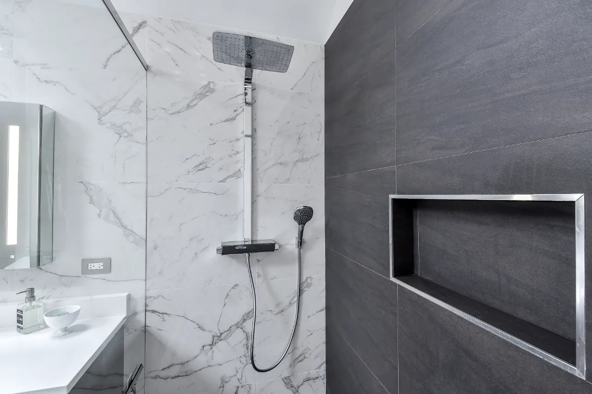 A modern-crisp primary bath remodel in Brentwood, TN. Wellborn Barcelona Oak Drift cabinetry, Orion Absolute White quartz, Atlas Concorde Calacatta Extra vanity wall, and Polished Chrome fixtures by Sebring Design Build.