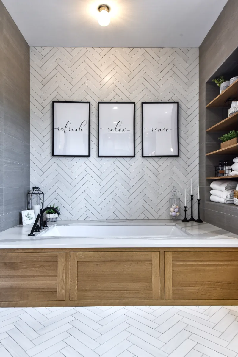 A transitional-elegant primary bath remodel in Franklin, TN. White Oak Sage cabinetry, Cambria Brittanicca Warm quartz, MTI Andrea soaking tub, and Dolomiti tile by Sebring Design Build.