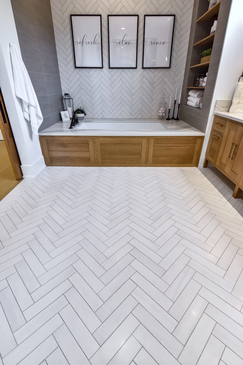 A transitional-elegant primary bath remodel in Franklin, TN. White Oak Sage cabinetry, Cambria Brittanicca Warm quartz, MTI Andrea soaking tub, and Dolomiti tile by Sebring Design Build.