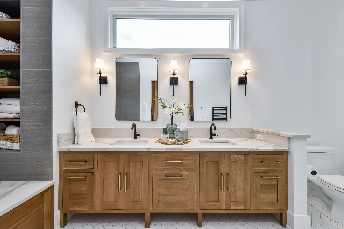 A transitional-elegant primary bath remodel in Franklin, TN. White Oak Sage cabinetry, Cambria Brittanicca Warm quartz, MTI Andrea soaking tub, and Dolomiti tile by Sebring Design Build.