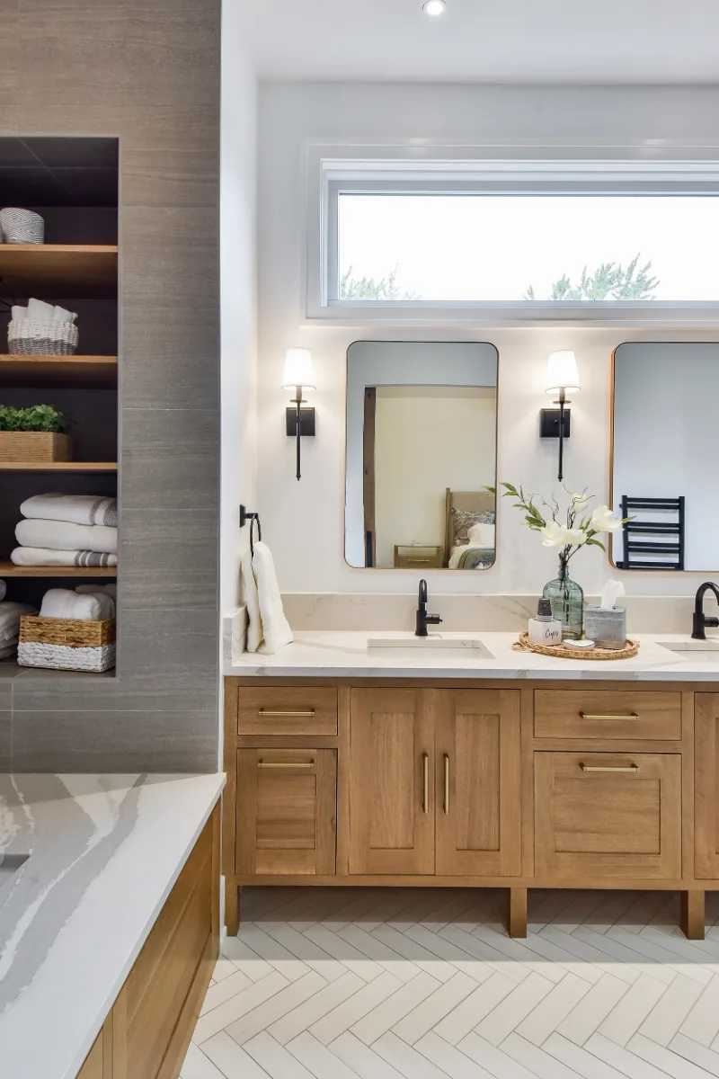 A transitional-elegant primary bath remodel in Franklin, TN. White Oak Sage cabinetry, Cambria Brittanicca Warm quartz, MTI Andrea soaking tub, and Dolomiti tile by Sebring Design Build.