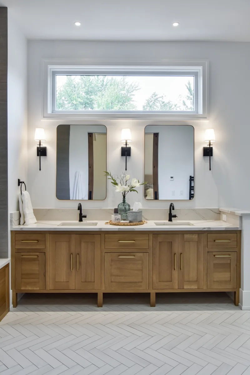A transitional-elegant primary bath remodel in Franklin, TN. White Oak Sage cabinetry, Cambria Brittanicca Warm quartz, MTI Andrea soaking tub, and Dolomiti tile by Sebring Design Build.