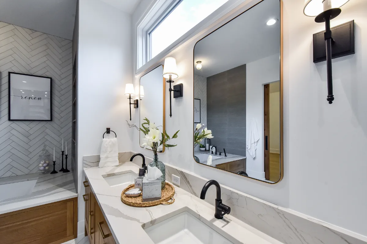 A transitional-elegant primary bath remodel in Franklin, TN. White Oak Sage cabinetry, Cambria Brittanicca Warm quartz, MTI Andrea soaking tub, and Dolomiti tile by Sebring Design Build.