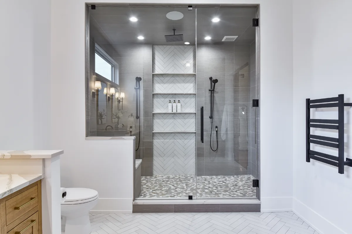 A transitional-elegant primary bath remodel in Franklin, TN. White Oak Sage cabinetry, Cambria Brittanicca Warm quartz, MTI Andrea soaking tub, and Dolomiti tile by Sebring Design Build.