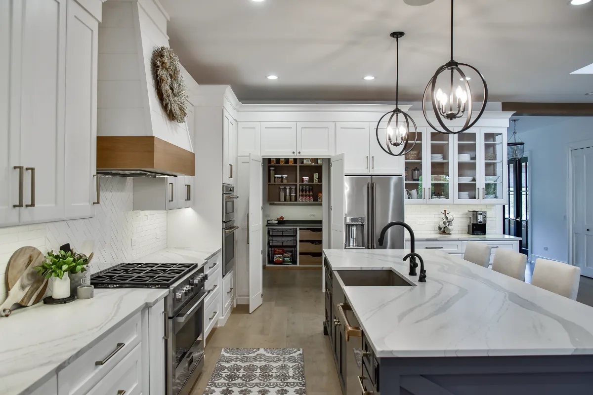 A transitional-elegant kitchen remodel in Franklin, TN. Snowbound and White Oak Sage cabinetry, Cambria Brittanicca Warm Matte quartz, and Zellige tile backsplash by Sebring Design Build.