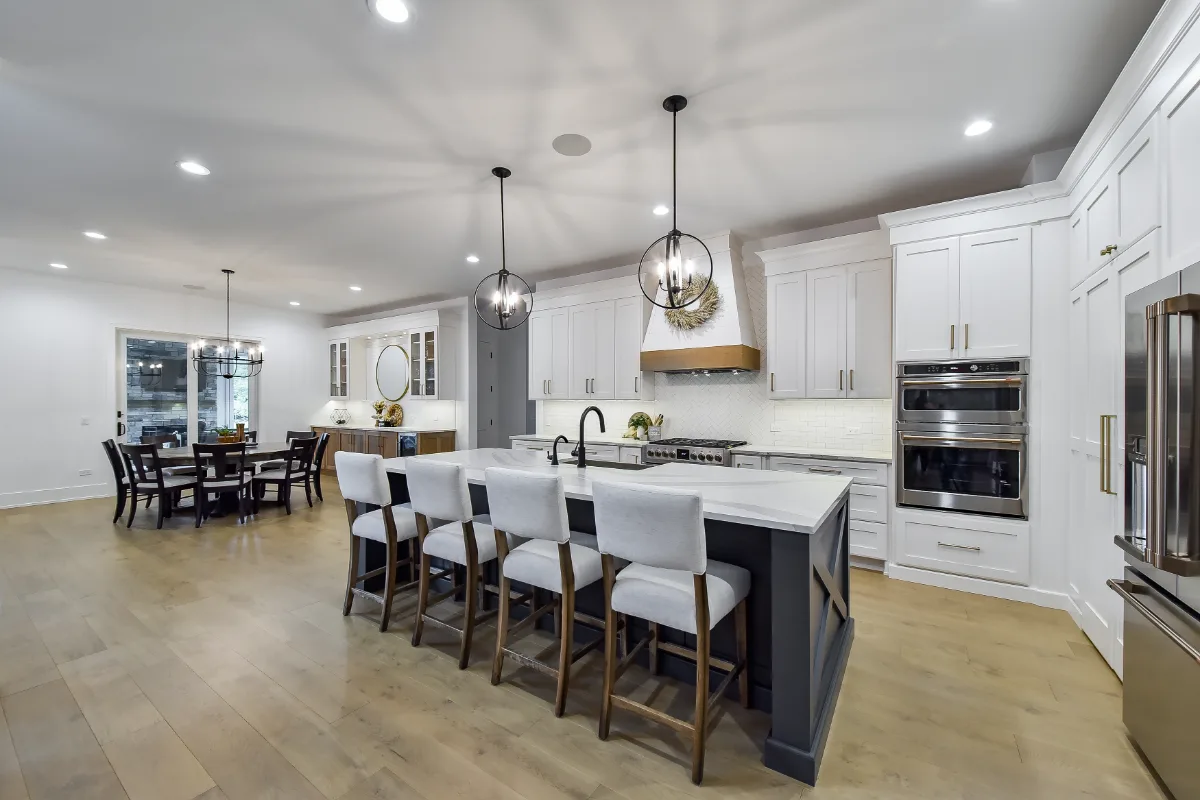 A transitional-elegant kitchen remodel in Franklin, TN. Snowbound and White Oak Sage cabinetry, Cambria Brittanicca Warm Matte quartz, and Zellige tile backsplash by Sebring Design Build.