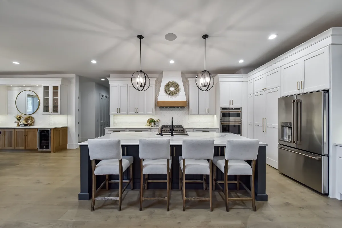A transitional-elegant kitchen remodel in Franklin, TN. Snowbound and White Oak Sage cabinetry, Cambria Brittanicca Warm Matte quartz, and Zellige tile backsplash by Sebring Design Build.