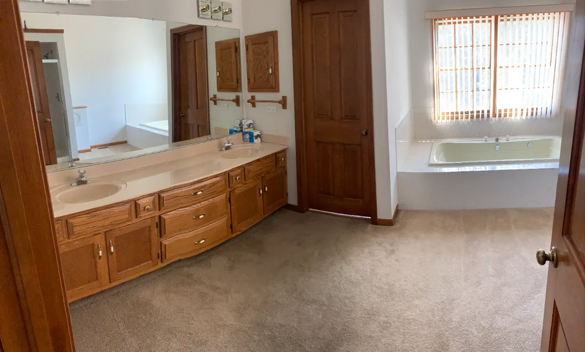 A modern-black-white primary bath remodel in Franklin, TN. Bellmont 1600 Studio White cabinetry, Cambria Deligatie quartz, Kohler Pivotal Matte Black, MTI Andrea tub, and MSI Kenzzi Paloma tile by Sebring Design Build.