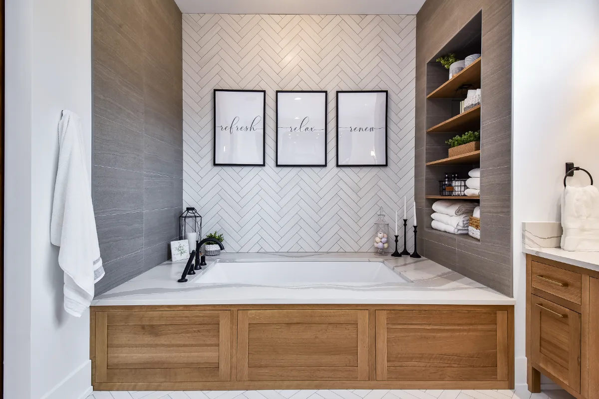 A transitional-elegant primary bath remodel in Franklin, TN. White Oak Sage cabinetry, Cambria Brittanicca Warm quartz, MTI Andrea soaking tub, and Dolomiti tile by Sebring Design Build.