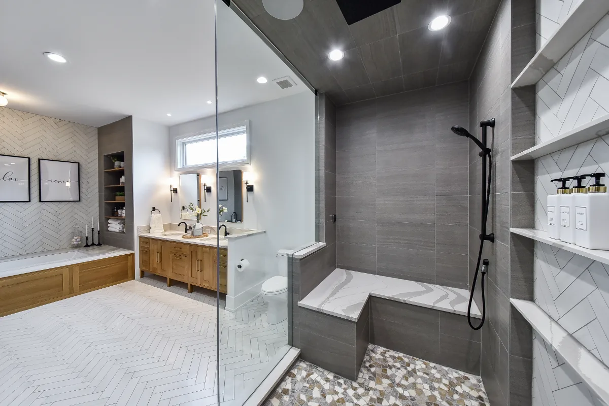 A transitional-elegant primary bath remodel in Franklin, TN. White Oak Sage cabinetry, Cambria Brittanicca Warm quartz, MTI Andrea soaking tub, and Dolomiti tile by Sebring Design Build.