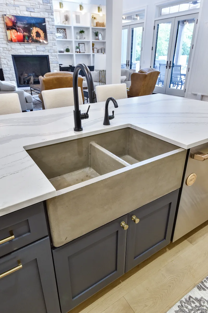 A transitional-elegant kitchen remodel in Franklin, TN. Snowbound and White Oak Sage cabinetry, Cambria Brittanicca Warm Matte quartz, and Zellige tile backsplash by Sebring Design Build.