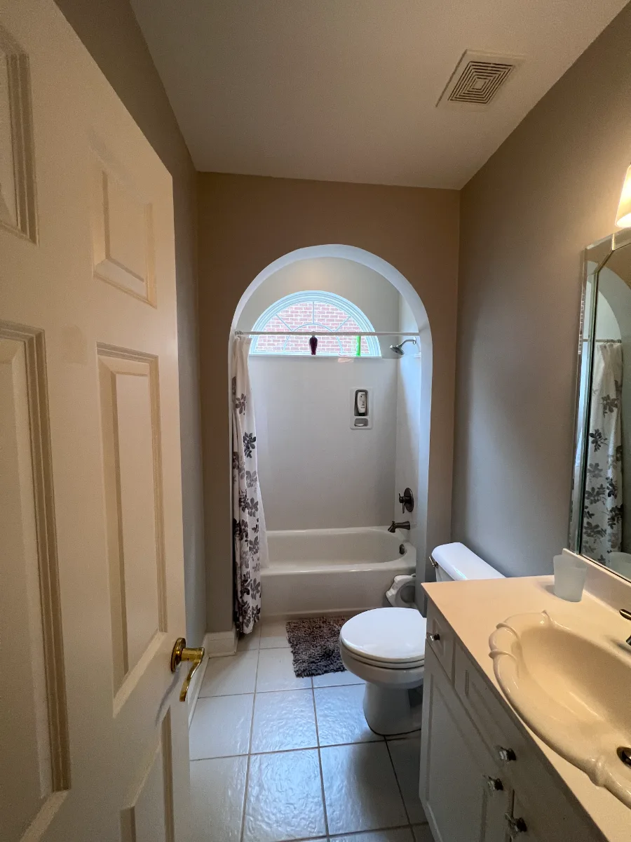 A coastal-elegant guest bath remodel in Willowsprings, Franklin TN 37064. Craftsman Square cabinetry, Calacatta Gold quartz, and Kohler Champagne Bronze by Sebring Design Build.