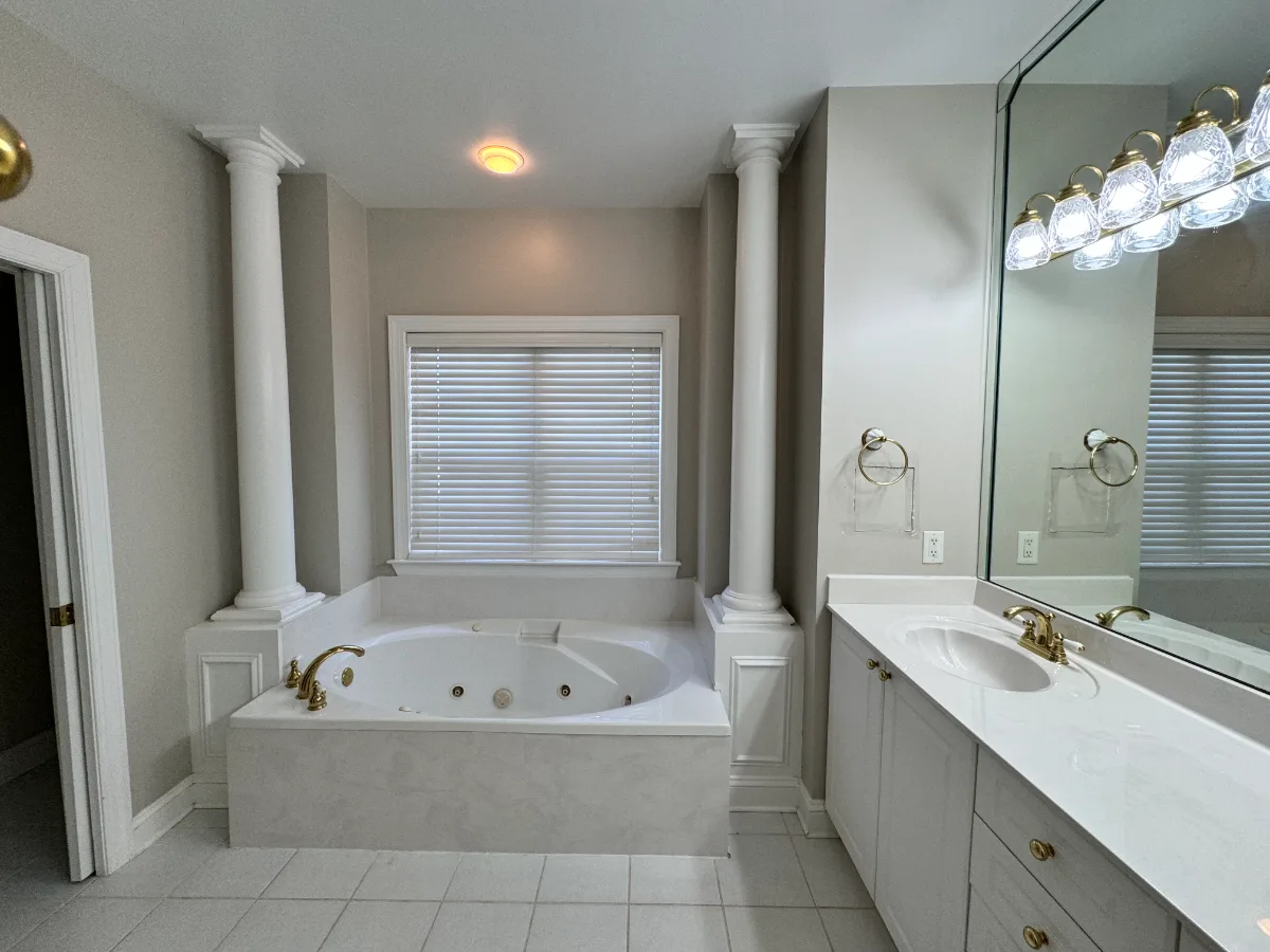 A coastal-elegant primary bath remodel in Willowsprings, Franklin TN 37064. Alder cabinetry, Calacatta Gold quartz, and Kohler Champagne Bronze by Sebring Design Build.