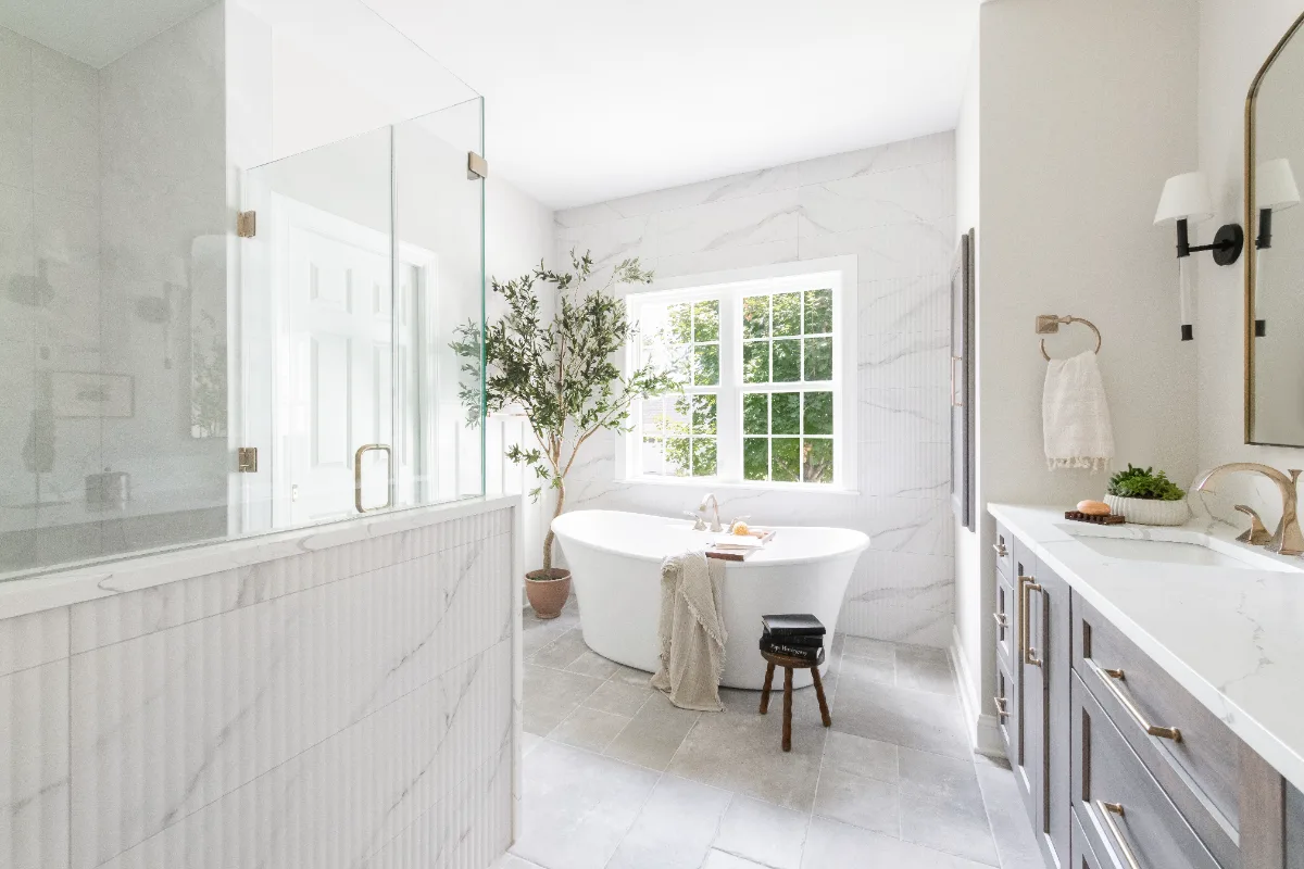 A coastal-elegant primary bath remodel in Willowsprings, Franklin TN 37064. Alder cabinetry, Calacatta Gold quartz, and Kohler Champagne Bronze by Sebring Design Build.