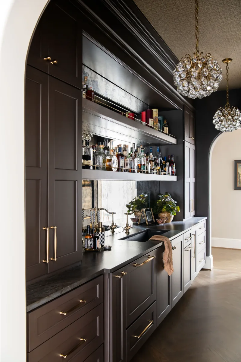 Bar remodel in McGavock Farms, Brentwood. Dark White Oak Rift Sawn cabinetry, antique mirror tile, open shelving, and brass fixtures by Sebring Design Build.