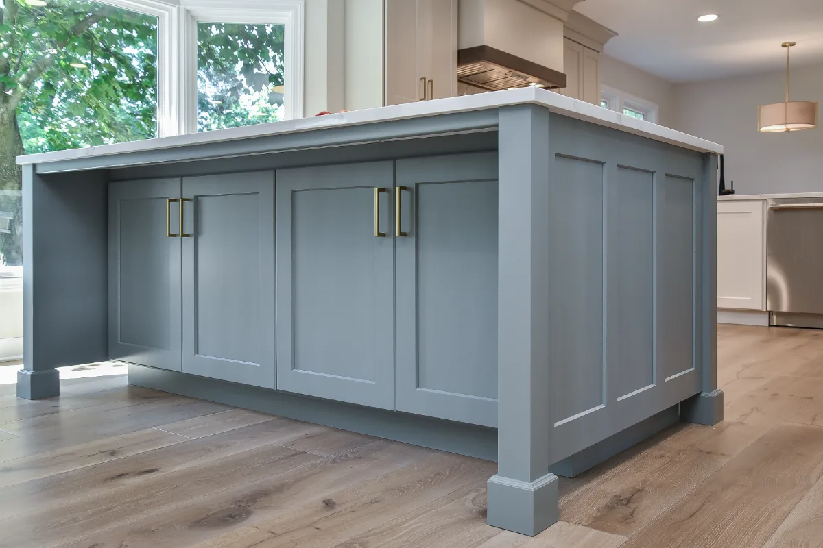 A Franklin, TN kitchen remodel with custom cabinetry in soft white, dune, and Puget Sound blue. Calacatta Aria quartz and Berenson Metro hardware by Sebring Design Build.