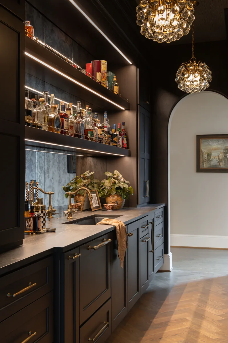 Bar remodel in McGavock Farms, Brentwood. Dark White Oak Rift Sawn cabinetry, antique mirror tile, open shelving, and brass fixtures by Sebring Design Build.