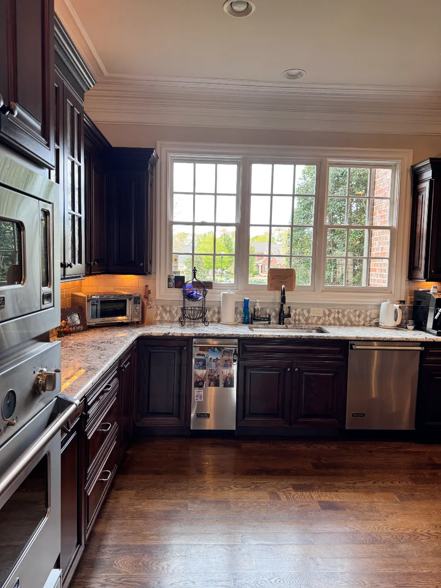Custom kitchen remodel in McGavock Farms, Brentwood. White oak rift sawn island, Maison Blanche cabinetry, Calacatta quartz, and brass fixtures by Sebring Design Build.