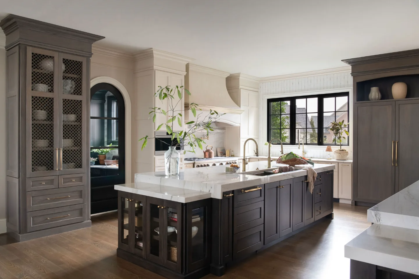 Custom kitchen remodel in McGavock Farms, Brentwood. White oak rift sawn island, Maison Blanche cabinetry, Calacatta quartz, and brass fixtures by Sebring Design Build.
